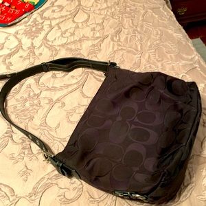 Coach purse with side pocket and lots of area inside.